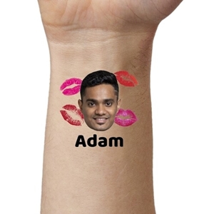 Close-up of an arm featuring a temporary tattoo with a man's face surrounded by colourful lipstick kiss marks and the name 