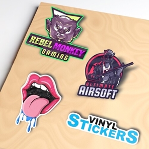 A set of colourful vinyl die-cut stickers on a beige surface. Designs include a 