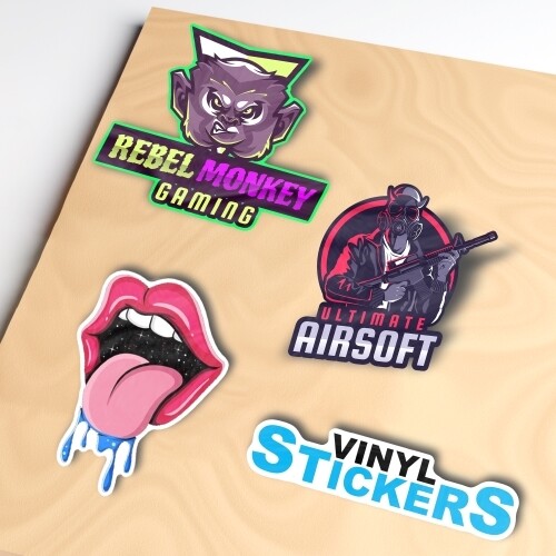 A set of colourful vinyl die-cut stickers on a beige surface. Designs include a 