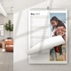 Personalised A4 wall planner displayed in a home with a father-and-daughter photo and May 2027 daily lines.