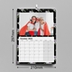 An A4 wall calendar displaying October 2025, with dimensions of 210mm width and 297mm height. The featured image shows three people wearing superhero capes and masks, smiling together. The calendar has a black floral border and spiral binding.