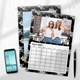 Personalised A4 April 2027 photo calendar with two friends, displayed beside a smartphone and pen.
