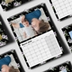 A wall calendar showing March 2025, featuring a photo of a parent lying on a bed with a baby, both looking at the camera. The black floral border surrounds the page, and the calendar has a spiral binding with a hanging hook at the top.