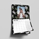 wall calendar hanging on the wall with black background and flowers with your own images and calendar block underneath