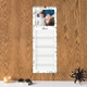 Green leaf personalised photo kitchen planner hanging on a wooden wall with lined daily spaces.