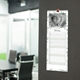 Slim green leaf personalised photo kitchen calendar displayed on a wall with writing space for each day.