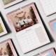 A December 2025 page from an A4 pink glitter-themed photo calendar. The image features a family posing in front of a Christmas tree with festive decorations. The calendar includes a large monthly grid layout.