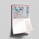 An A4 wall calendar for January 2025 with a pink glitter border. The page features a photo of a child holding hands with two adults at the beach, with a monthly grid below. The calendar is spiral-bound with a hanging hook.