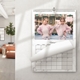 Personalised marble A3 photo calendar displayed on a wall with a family picture and turning page.