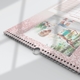 Close-up of a pink personalised A3 photo calendar showing the wire binding and hanging hook.