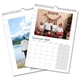 An A4 photo calendar showing January. One image features a family holding hands on a beach, and the other shows a child holding a baby. The calendar is spiral-bound with space for your images above each month.