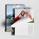 An A4 photo calendar  featuring your own photo or picture on the top page. The calendar is spiral-bound and partially open, revealing a blank month grid. Behind it, another personlaied image of your choice