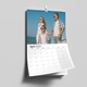 A 2025 A4 photo calendar opened to February, featuring your own photo or picture. The calendar is spiral-bound with a white hanging hook, showcasing a clean grid layout for daily notes and reminders.