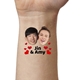 Close-up of an arm featuring a temporary tattoo with two smiling faces labelled 