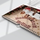 Close-up of a wire-bound personalised A3 calendar featuring a family Christmas photograph and 2027 grid.