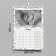 A wall calendar for February, measuring 420mm by 297mm, with a leafy border. The page features a calendar grid and a black-and-white photo of two adult hands forming a heart around a baby's feet.