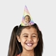 Smiling girl wearing a customised party hat with a rainbow stripe design, a personalised photo of a smiling boy, and the text Eli's 6. Perfect for celebrating a 6th birthday or a colourful, fun-themed party.