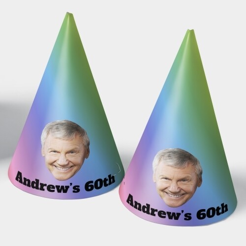 Two customised party hats with a gradient design featuring a smiling man's face and bold text reading Andrews 60th, perfect for milestone birthday celebrations.