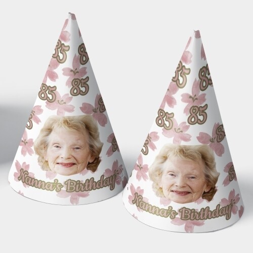 Two customised party hats with a white background, personalised with your photo and number of your choice. The hats are displayed upright side by side. Perfect for birthdays or celebrations.