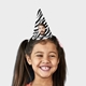 Smiling girl wearing a customised party hat with your own face and number. The girl has pigtails and is laughing, showcasing the fun design. Ideal for birthdays or themed celebrations.