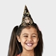 Smiling girl wearing a customised party hat with your own face and number. The girl has pigtails and is laughing, showcasing the fun design. Ideal for birthdays or themed celebrations.