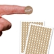 A small round personalised Kraft label with white print shown on a fingertip above two sheets filled with identical custom stickers. The brown labels have a striped texture and bold white text reading White Print Kraft Labels, ideal for crafts, packaging or branding.