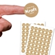 A small round personalised Kraft label with white print shown on a fingertip above two sheets filled with identical custom stickers. The brown labels have a striped texture and bold white text reading White Print Kraft Labels, ideal for crafts, packaging or branding.