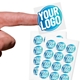 Transparent custom square label sticker with a blue and white logo, shown on a fingertip, alongside two sheets filled with multiple identical stickers. Ideal for personalised branding or product labelling.