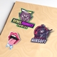 A set of colourful vinyl die-cut stickers on a beige surface. Designs include a 