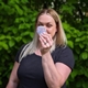 A woman holding a personalised makeup mirror